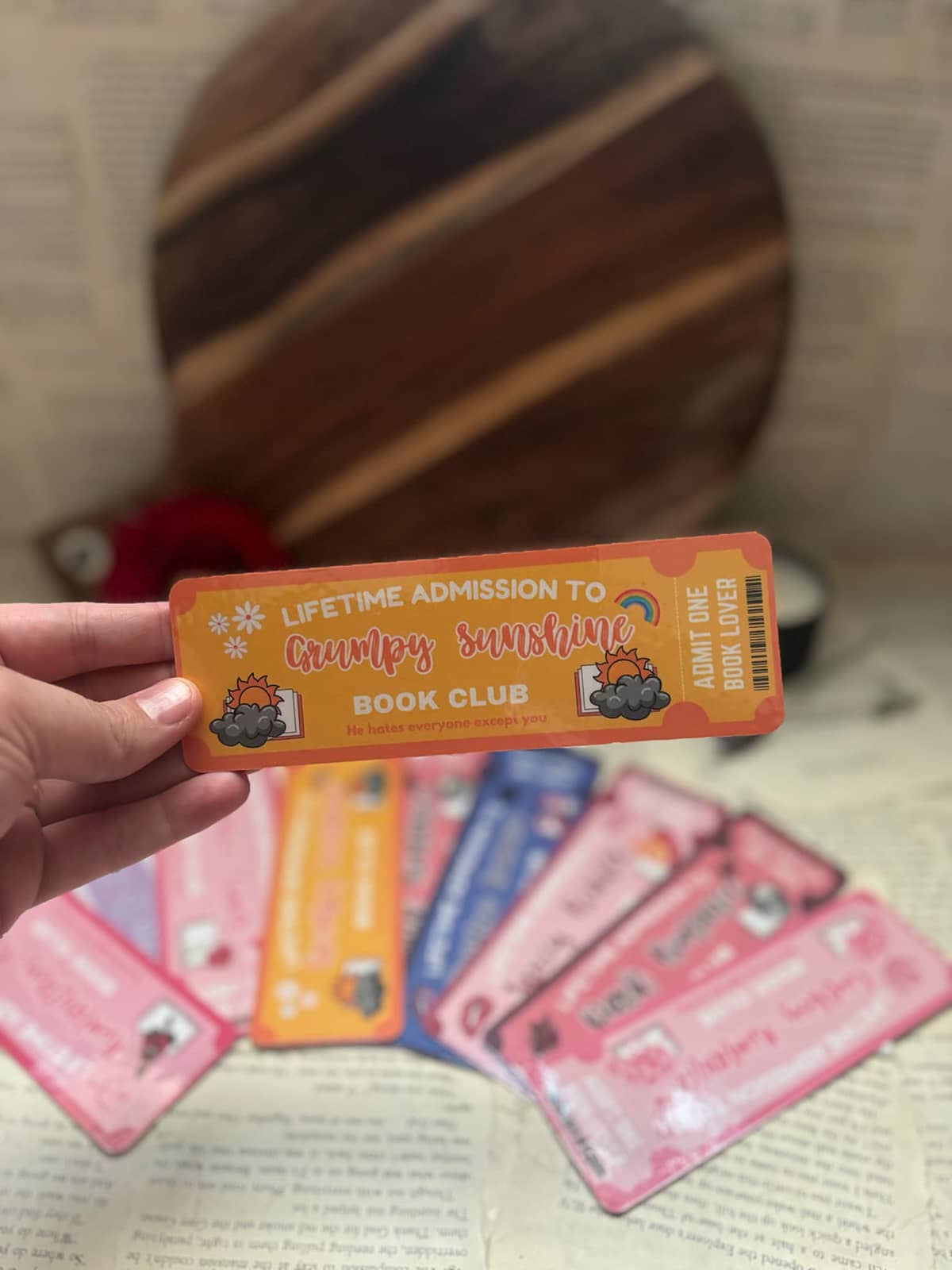 Book Club bookmark featuring orange admission ticket design and graphic text "Lifetime admission to grumpy sunshine book club; he hates everyone except you"