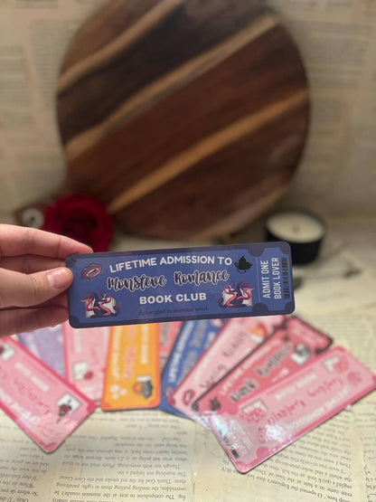 Book Club bookmark featuring blue admission ticket design and graphic text "Lifetime admission to monster romance book club; entangled in monster smut"