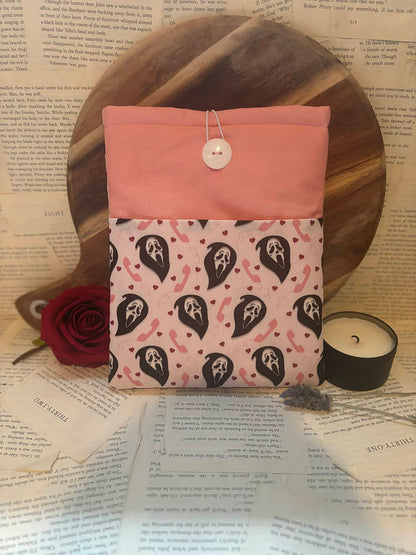 Book sleeve featuring Scream horror mask design on pastel pink background with telephone and love heart pattern