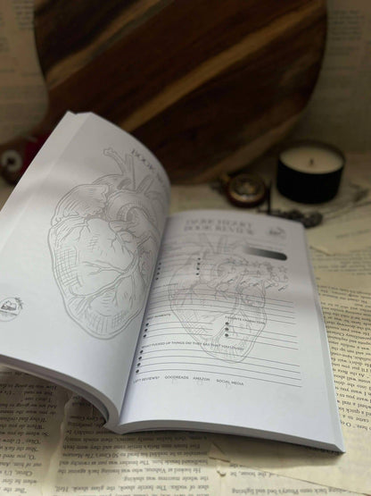 The Indie Realm Dark Hearts Dark Romance Book Review Journal, featuring book review prompts and bullet journal lines on pages inside