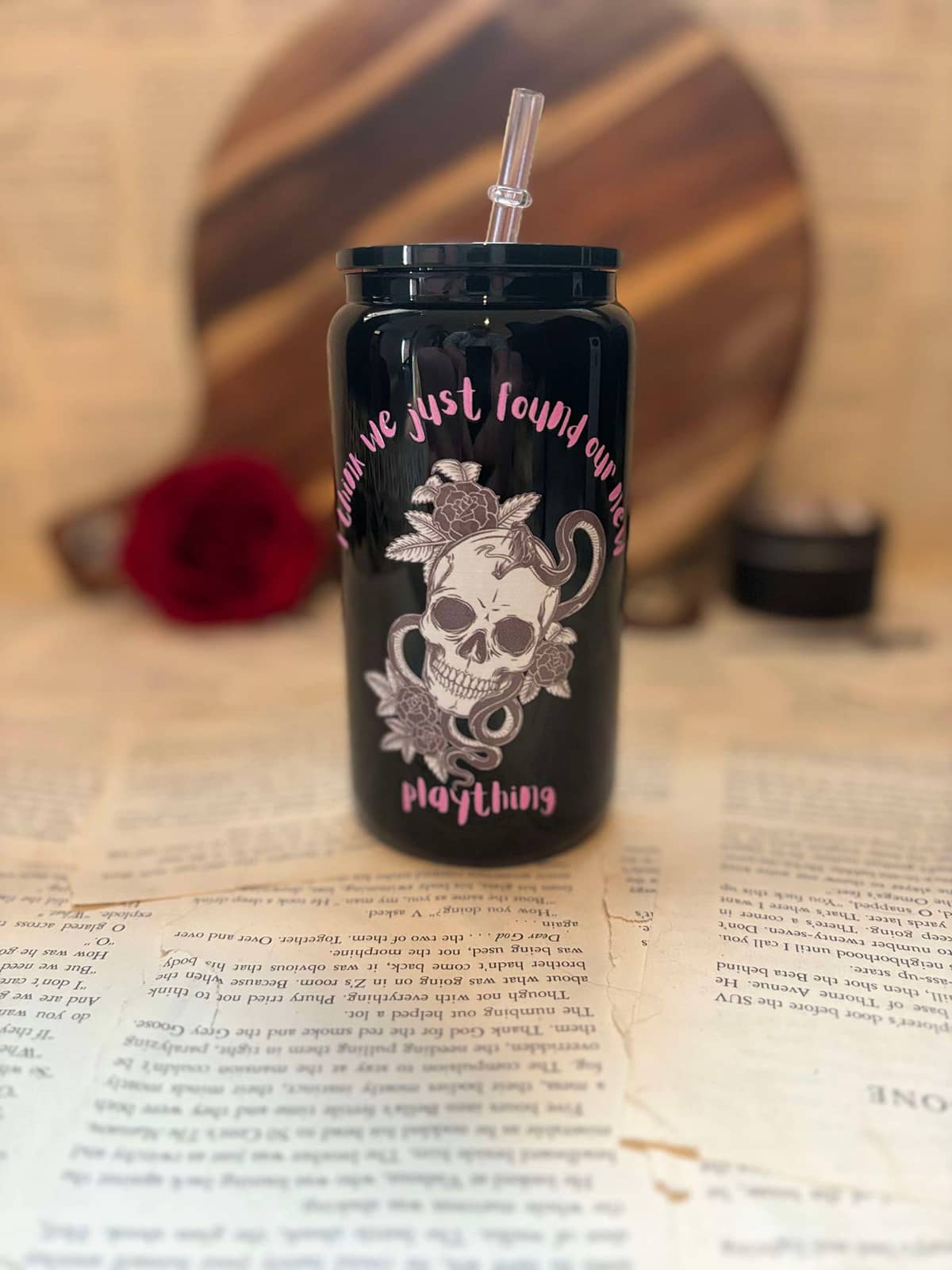 Layla Moon's Twisted Friction themed  frosted glass cup featuring skull, flowers and snake design with pink graphic text on glossy black tumbler and lid, with clear straw