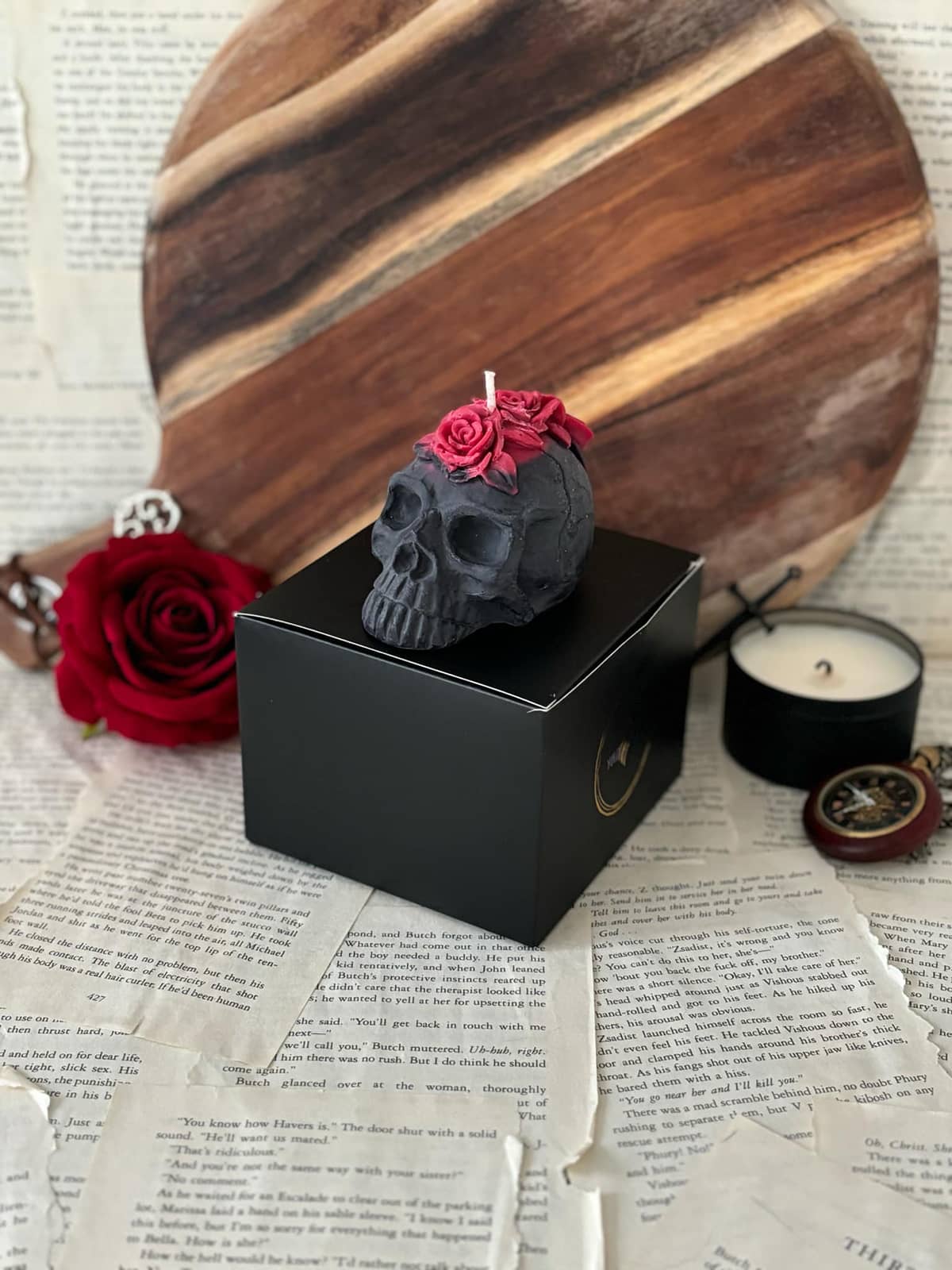 Candle in the shape of black skull with red roses on top