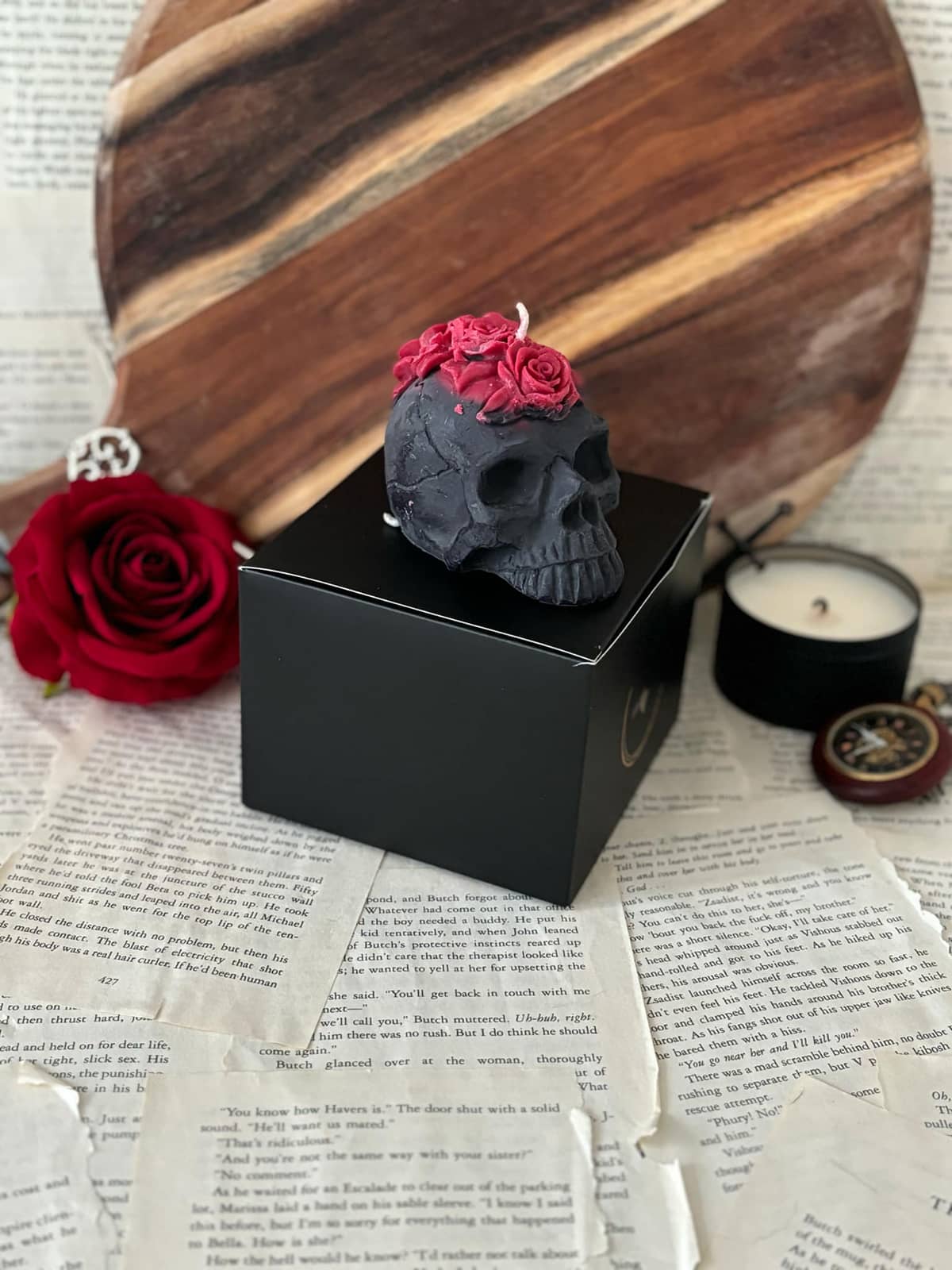 Candle in the shape of black skull with red roses on top